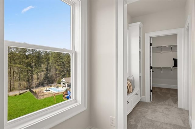 hallway with light colored carpet