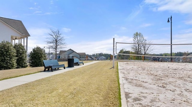 view of property's community featuring volleyball court and a yard