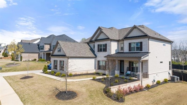 view of front of house with central AC unit, a porch, and a front yard