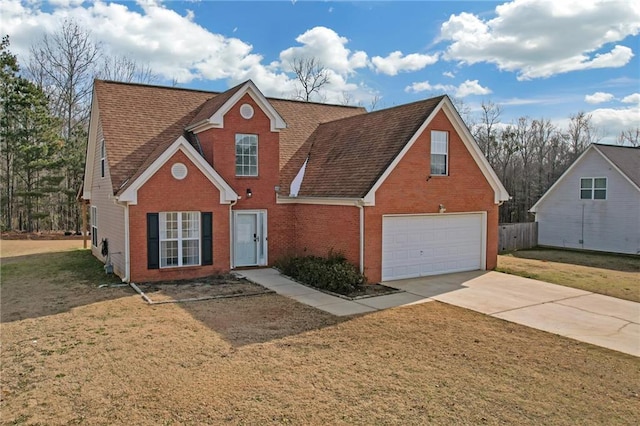 view of front of property featuring a garage and a front lawn