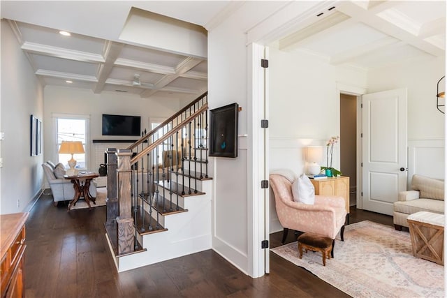 staircase with beam ceiling, ornamental molding, coffered ceiling, and hardwood / wood-style floors