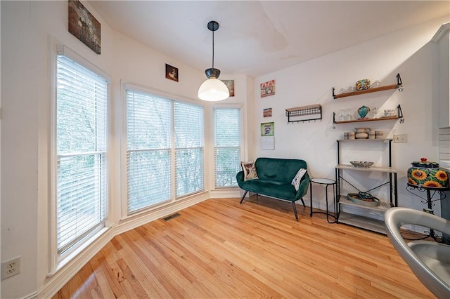 living area with visible vents and light wood finished floors