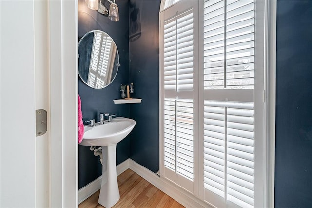 bathroom with baseboards and wood finished floors