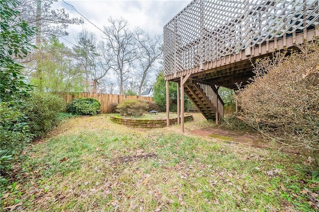 view of yard featuring stairs, fence, and a wooden deck