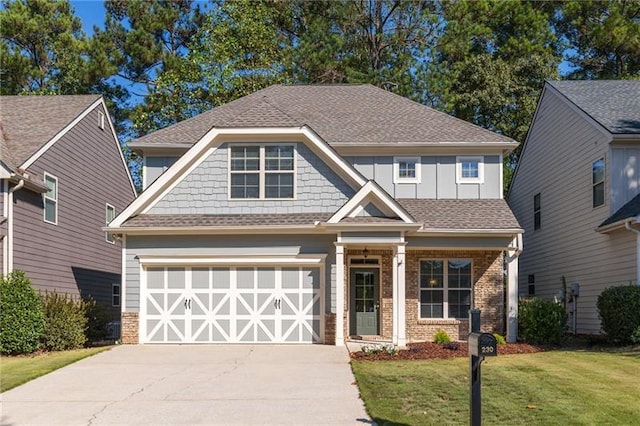 craftsman inspired home featuring a garage and a front yard