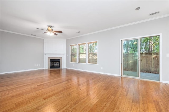 unfurnished living room featuring ceiling fan, light hardwood / wood-style flooring, ornamental molding, and a healthy amount of sunlight