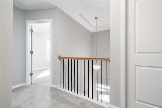 hallway with lofted ceiling and light carpet