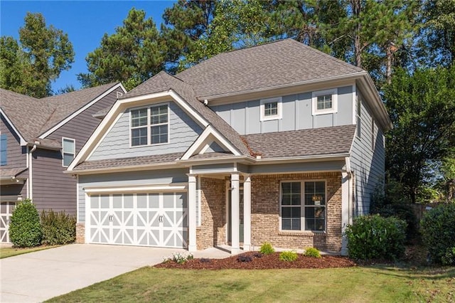 craftsman house with a garage and a front yard