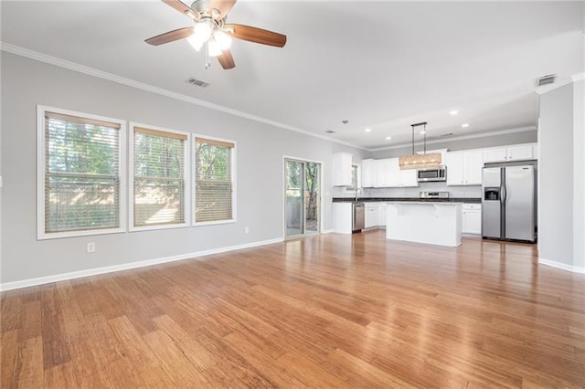 unfurnished living room with crown molding, light hardwood / wood-style floors, and ceiling fan