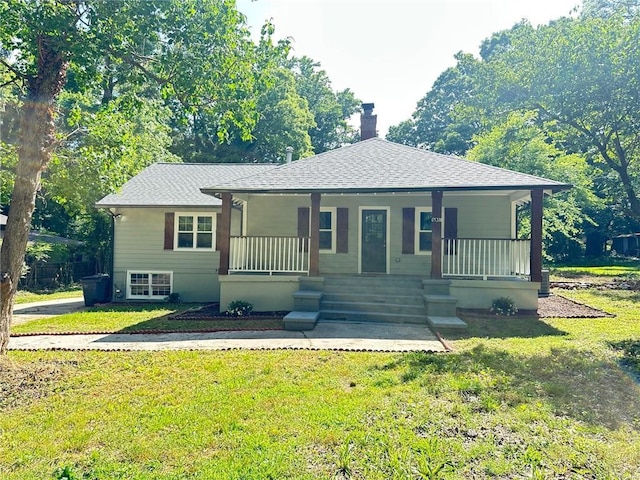 6538 N Sweetwater Rd, Lithia Springs, GA 30122 - bungalow with a chimney, covered porch, roof with shingles, and a front lawn