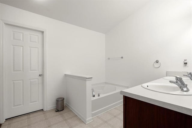 bathroom with a bathing tub and vanity