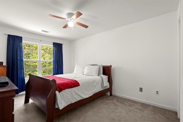 bedroom with ceiling fan and light carpet