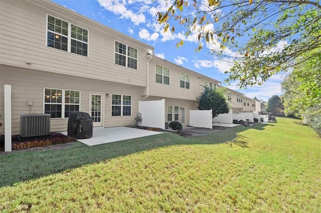 back of house featuring a yard, central AC, and a patio area