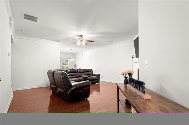 living room featuring hardwood / wood-style flooring, ceiling fan, and ornamental molding