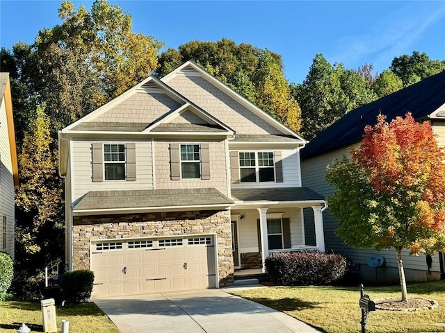 craftsman-style home featuring a garage and a front lawn