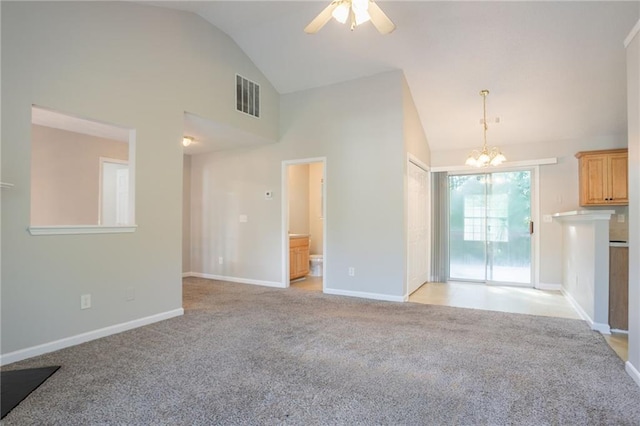 5033 Kens Ct, Stockbridge, GA 30281 - unfurnished living room featuring light colored carpet, a chandelier, ceiling fan, and high vaulted ceiling