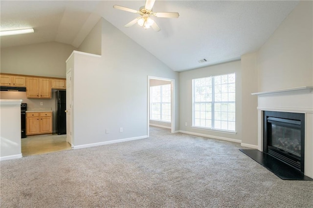 5033 Kens Ct, Stockbridge, GA 30281 - unfurnished living room featuring light carpet, a ceiling fan, high vaulted ceiling, and a glass covered fireplace