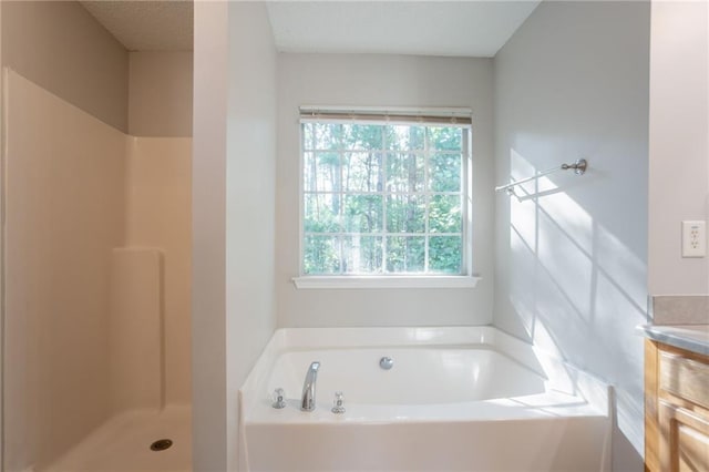 5033 Kens Ct, Stockbridge, GA 30281 - full bathroom featuring plenty of natural light, a garden tub, a shower, and vanity