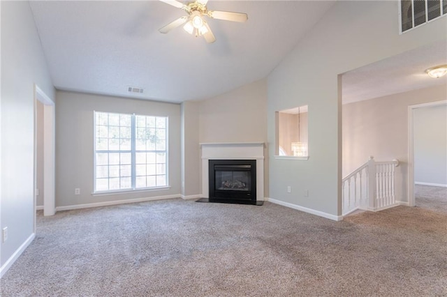 5033 Kens Ct, Stockbridge, GA 30281 - unfurnished living room with carpet floors, vaulted ceiling, ceiling fan, and a fireplace with flush hearth