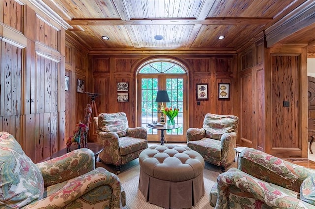 living area featuring wood ceiling and wood walls