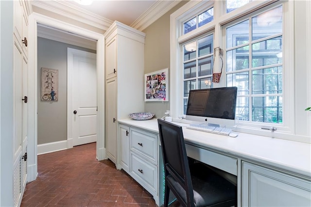 home office featuring crown molding and built in desk