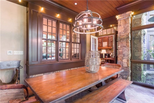 dining space with a notable chandelier, ornamental molding, and wooden ceiling