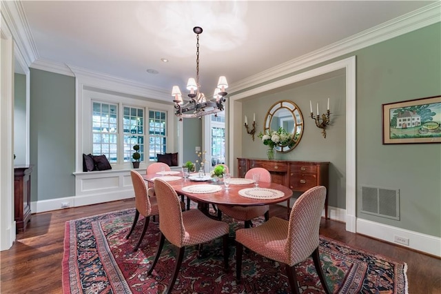 dining area with a notable chandelier, crown molding, and dark hardwood / wood-style floors