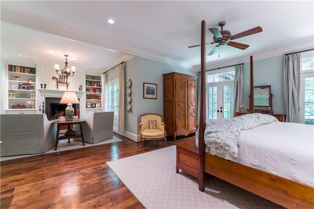 bedroom featuring crown molding, dark wood-type flooring, ceiling fan with notable chandelier, and french doors