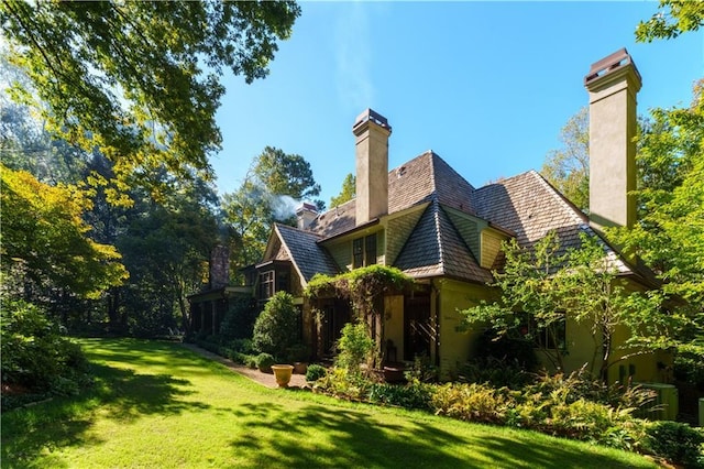 view of side of property with a lawn