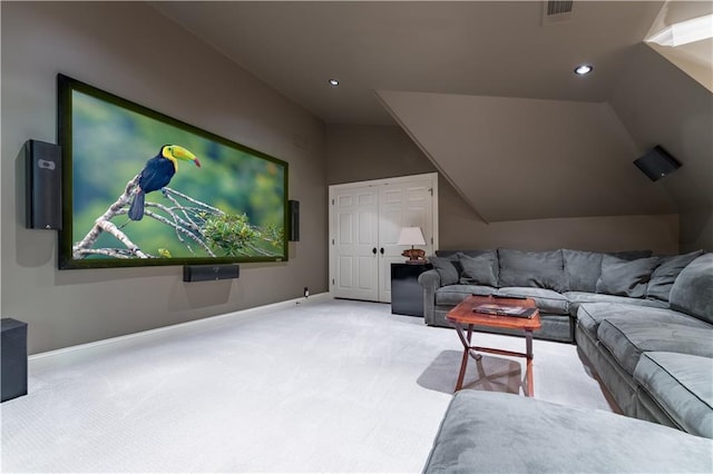 carpeted home theater room featuring vaulted ceiling