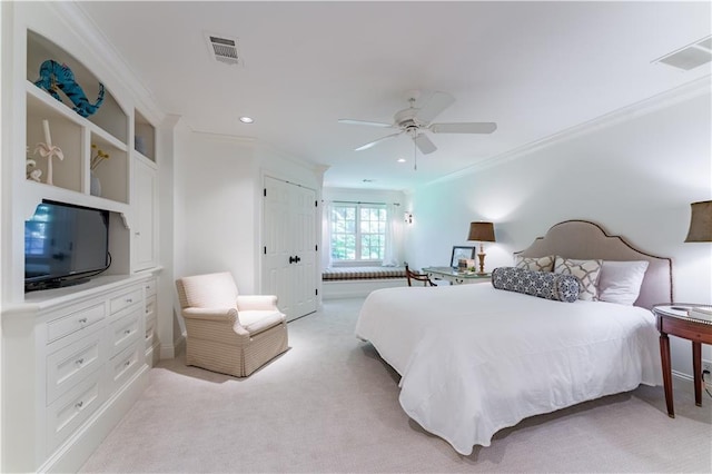 carpeted bedroom featuring crown molding, ceiling fan, and a closet