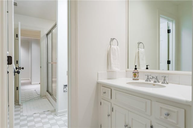 bathroom featuring vanity and an enclosed shower