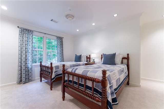 bedroom with ornamental molding, light colored carpet, and ceiling fan