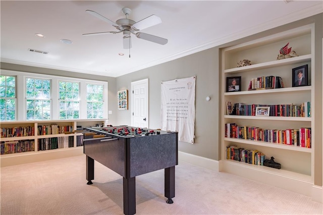 playroom with crown molding, light colored carpet, and ceiling fan