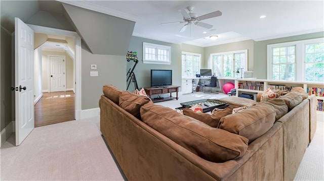 living room featuring crown molding, light colored carpet, and ceiling fan