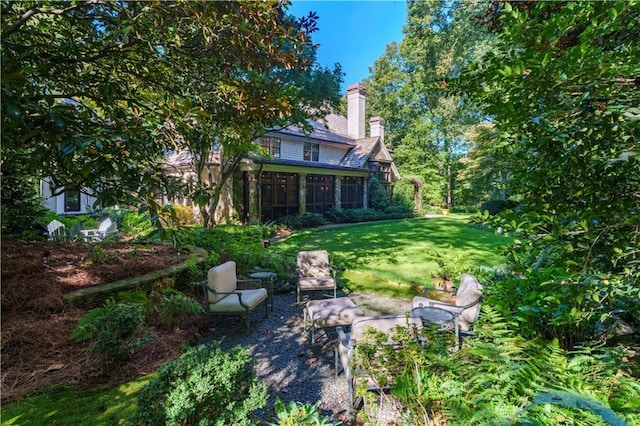 view of yard with a patio and a sunroom