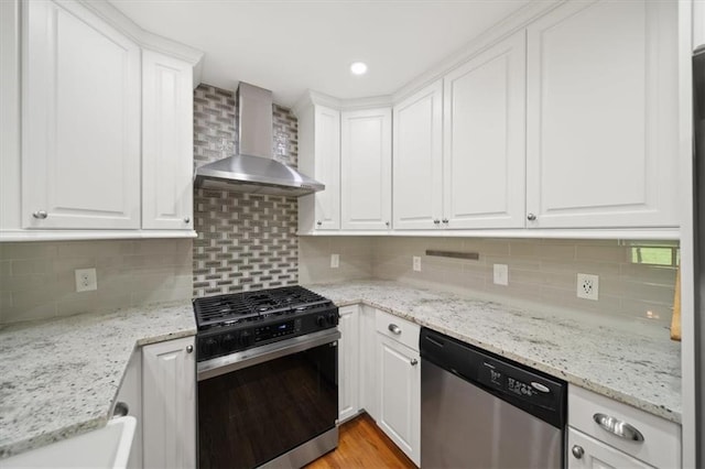 2100 Shady Ln, Tucker, GA 30084 - kitchen with range with gas stovetop, stainless steel dishwasher, wall chimney range hood, white cabinets, and recessed lighting