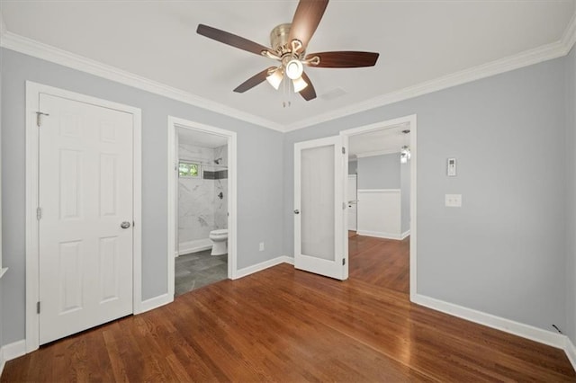 2100 Shady Ln, Tucker, GA 30084 - unfurnished bedroom with baseboards, ornamental molding, wood finished floors, a ceiling fan, and connected bathroom