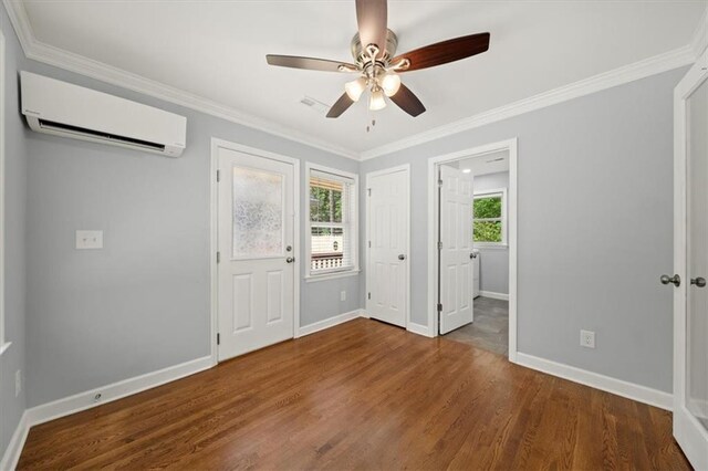 2100 Shady Ln, Tucker, GA 30084 - unfurnished bedroom with a wall mounted AC, baseboards, wood finished floors, ornamental molding, and ceiling fan