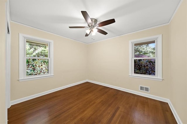 2100 Shady Ln, Tucker, GA 30084 - empty room featuring plenty of natural light, dark wood finished floors, baseboards, crown molding, and a ceiling fan