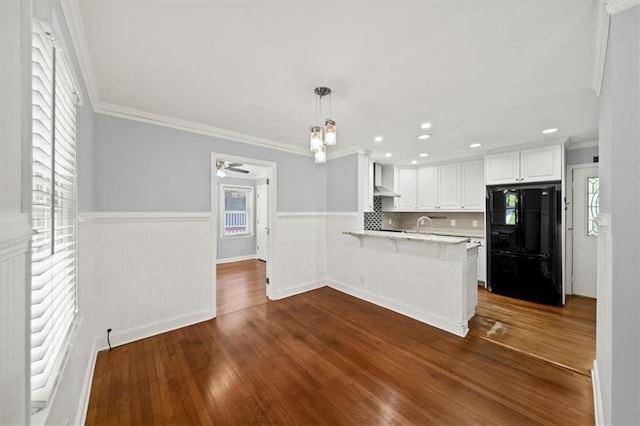2100 Shady Ln, Tucker, GA 30084 - kitchen with freestanding refrigerator, a peninsula, light countertops, healthy amount of natural light, and wainscoting