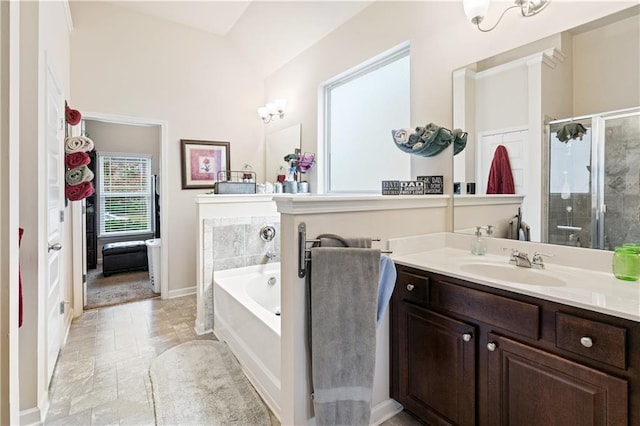 bathroom featuring independent shower and bath and vanity