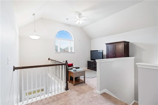 hall with light colored carpet and lofted ceiling