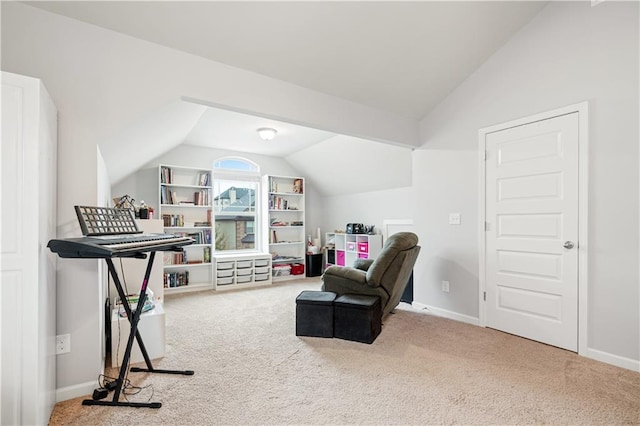 living area featuring carpet flooring and vaulted ceiling