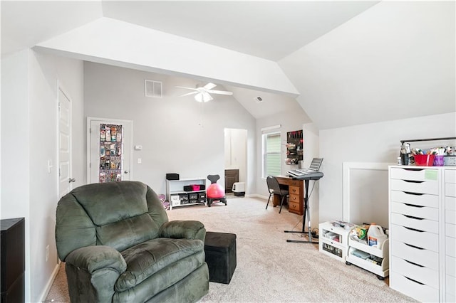 living area featuring carpet floors, ceiling fan, and vaulted ceiling