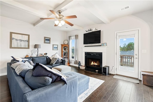 living room featuring dark wood-type flooring, ceiling fan, and beam ceiling