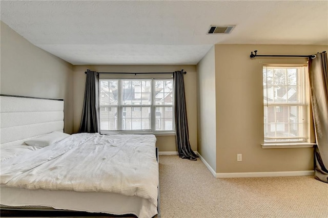 bedroom featuring light carpet