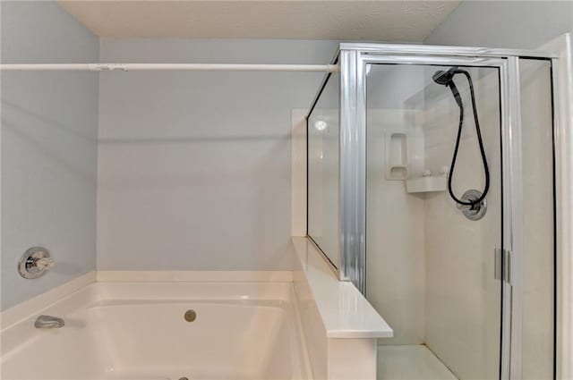 bathroom featuring shower with separate bathtub