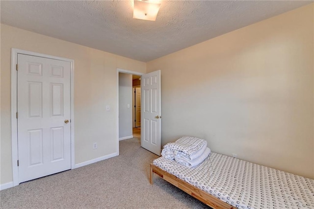 bedroom featuring a textured ceiling and carpet