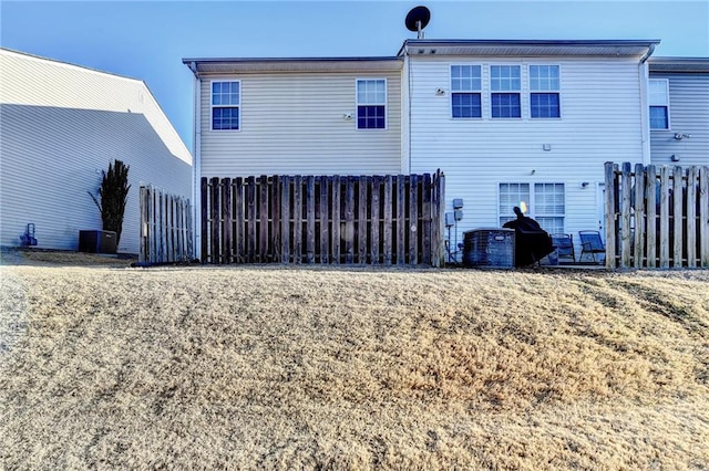 rear view of property with central AC unit